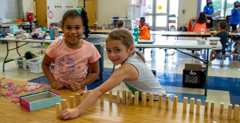 Two girls playing with blocks